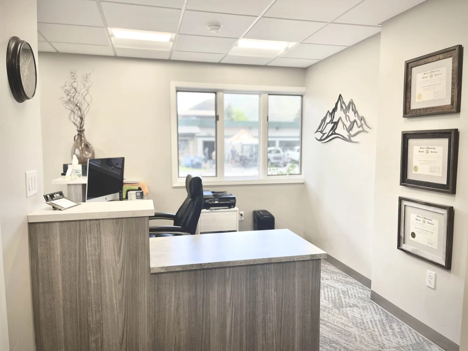 Check-in desk with mountain artwork at the Jackson office